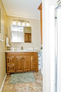a bathroom with a sink and a mirror at Cabin by the Creek with private creek access in Tannersville