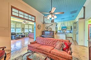 a living room with a couch and a kitchen at The Lilly House Historic Glen Rose Home with Porch! in Glen Rose