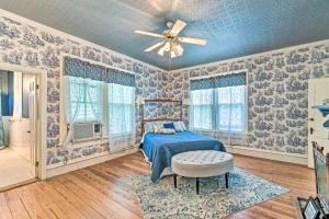 a bedroom with a bed and a ceiling fan at The Lilly House Historic Glen Rose Home with Porch! in Glen Rose