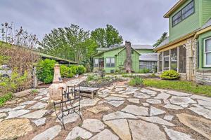 a home with a stone patio in front of a house at The Lilly House Historic Glen Rose Home with Porch! in Glen Rose