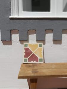a coaster sitting on a table in front of a window at Casa Lara by HnM in Tavira
