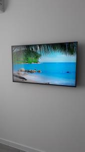 a television hanging on a wall in a living room at Комфортная квартира по проспекту Коцюбинского , жк Туркиш Сити in Vinnytsya