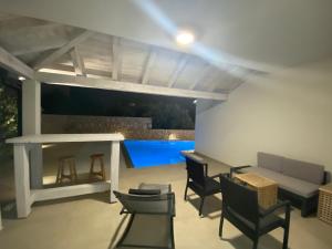 a patio with a table and chairs and a pool at Villa Papalina 3 in Barbat na Rabu