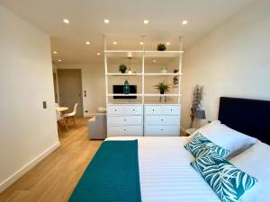 a bedroom with a large bed with a dresser at Magnifique Studio à deux pas du port de Saint-Tropez in Saint-Tropez