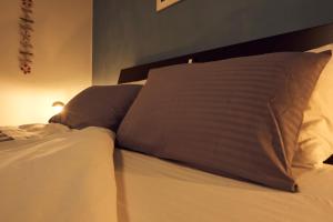 a bed with two pillows on top of it at il Magàn - Cinque Terre in Corniglia