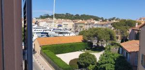 a view of a city with boats in a harbor at Magnifique Studio à deux pas du port de Saint-Tropez in Saint-Tropez