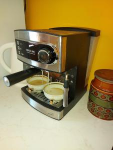 a coffee maker with two bowls on top of it at Apartament Retro Promenada in Ełk