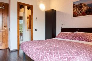 a bedroom with a bed with a purple comforter at il Magàn - Cinque Terre in Corniglia