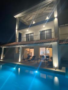a villa with a swimming pool at night at Villa Papalina 3 in Barbat na Rabu