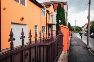 a wooden fence in front of a house at GUITAR - Camere de Inchiriat in Sibiu