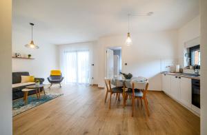 a kitchen and living room with a table and chairs at Ledunis in Šibenik