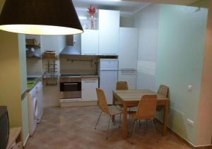 a kitchen with a dining room table and chairs at Casa da Praia Apartment - Alvor Beach in Alvor