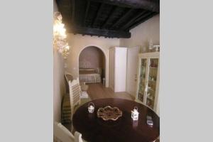 a dining room with a table and a bedroom at The Luxury Madonnina Suite in Vernazza