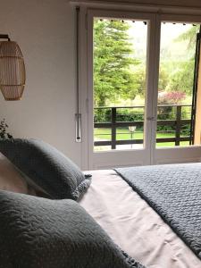 a bedroom with a bed and a large window at Els Avets de la Muga in Sant Llorenç de la Muga +14 photos