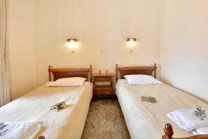 Postel nebo postele na pokoji v ubytování Adonis Apartments