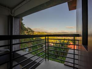 a room with a balcony with a view at Casa Bel in Baguio