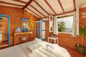 a room with a bed and a large window at Can Mocamp in Kaş +36 photos