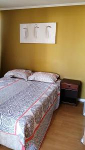 a bedroom with a bed with two pillows on it at Apartamento Metro Santa Lucia, Santiago Centro in Santiago
