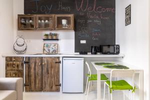 a kitchen with a table and a chalkboard on the wall at Naria Medieval House in Rhodes Town +18 photos