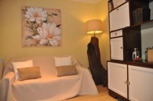 a bedroom with a white bed with two pillows on it at CASA BOREAL in Ourense