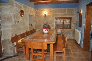 a dining room with a wooden table and chairs at CASA BOREAL in Ourense