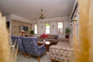 a living room with a couch and a table at Arden Hotel in Didim