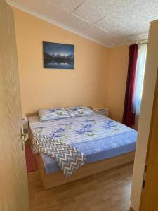 - une chambre avec un lit et une couette bleue dans l'établissement Apartment Zdenka, à Vir