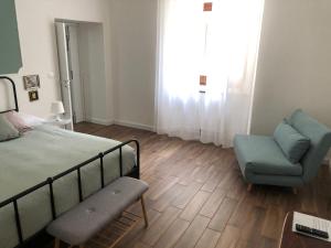 1 dormitorio con 1 cama, 1 sofá y 1 silla en La Casetta di Rosie, alla Torre Guevara, en Potenza