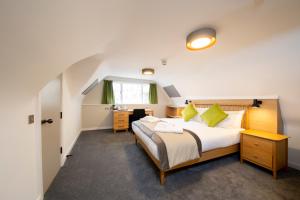 a bedroom with a large bed and a desk at Turl Street Mitre in Oxford