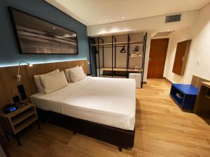a bedroom with a large white bed in a room at Hotel Senac Ilha do Boi in Vitória