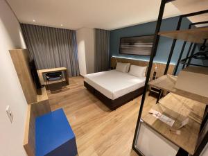 a hotel room with a bed and a desk at Hotel Senac Ilha do Boi in Vitória +37 photos