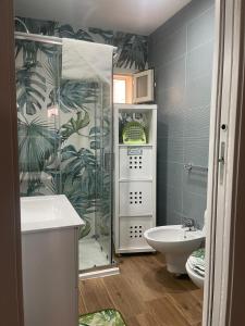 a bathroom with a shower and a toilet and a sink at Tropical House in Mola di Bari +10 photos