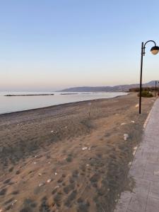 a beach with a street light next to the water at 42 Beach Coast Apartment in Polis Chrysochous