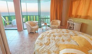 a bedroom with a bed and a view of the ocean at KAKTUS Hotel Kaktus Albir in Albir