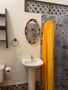 a bathroom with a sink and a mirror on the wall at Macao Beach in Sámara