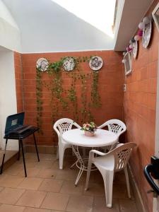 a table and chairs in front of a brick wall at CASA la PAU in Vilassar de Mar