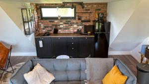 a living room with a couch and a kitchen at Casa cu obloane, sat Pestera, Moieciu in Moieciu de Jos +24 photos