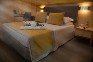 a bedroom with a large bed with yellow pillows at B&B Lapillus in Pompei