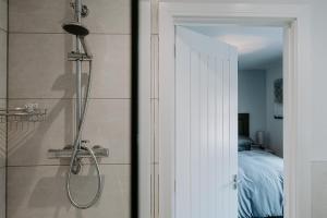 a bathroom with a shower next to a bedroom at The Royal Oak in Heckington +23 photos