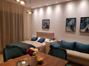 a room with a bed and a couch and a table at Azura Residence - new luxury apartment in Belgrade