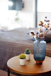 un vase avec des fleurs et des plantes sur une table dans l'établissement AP Baltic Mielno, à Mielno