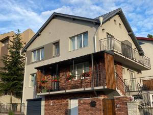 an apartment building with flowers on the balcony at TamTam Urban in Cluj-Napoca