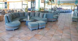 a lobby with a couch and chairs in a restaurant at KAKTUS Hotel Kaktus Albir in Albir