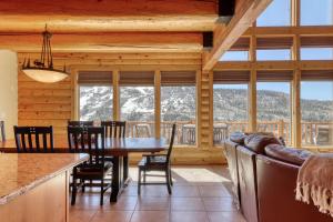 a dining room and living room with a table and chairs at Ski-View Lodge in Brian Head