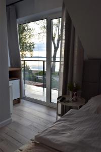 Postel nebo postele na pokoji v ubytování Rewianka Apartamenty przy samej plaży