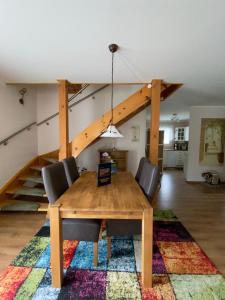 a dining room with a table and chairs and a staircase at Grimming View in Niederöblarn