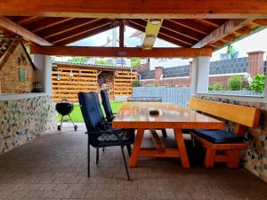 a wooden table and chairs on a patio at Ferienwohnung Otschik in Glan-Münchweiler