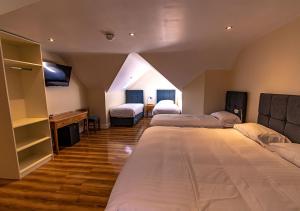 Ένα ή περισσότερα κρεβάτια σε δωμάτιο στο Aisling Guest House
