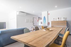 a dining room with a wooden table and chairs at Apartamento T2 Tin Tin in Nazaré