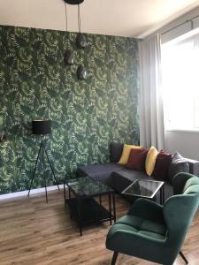 a living room with a couch and a green wall at Business Center in Skierniewice